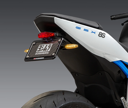 YOSHIMURA Fender Eliminator Kit for Suzuki motorcycles, showcasing sleek black design and mounting hardware on a white background.