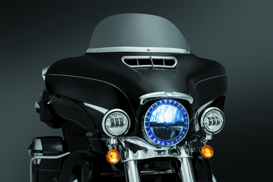 Chrome Kuryakyn Smooth Windshield Trim for Harley-Davidson Touring Models, part #1387, shown on a motorcycle.