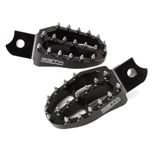 Black aluminum ZETA footpegs for motocross bikes, part number ZE93-1100, showing close-up of textured footrest surface and mounting points.
