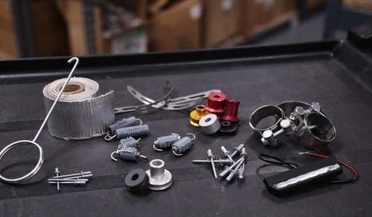 YOSHIMURA RS9-NB003 motorcycle muffler badge, small durable metal emblem with YOSHIMURA logo on a motorcycle exhaust.