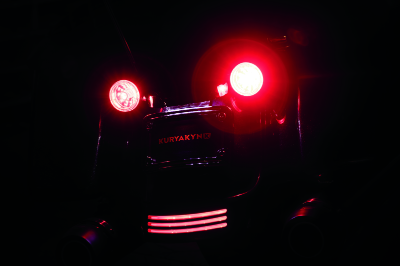 Kuryakyn 1157 Red/Red LED bulb for powersports dual function replacement, showing the bright red LED light and socket.