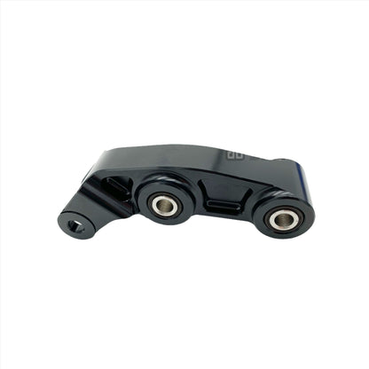 Black CNC aluminum suspension linkage for Surron LBX electric bike by eDirtyBike, designed for improved durability and suspension performance.