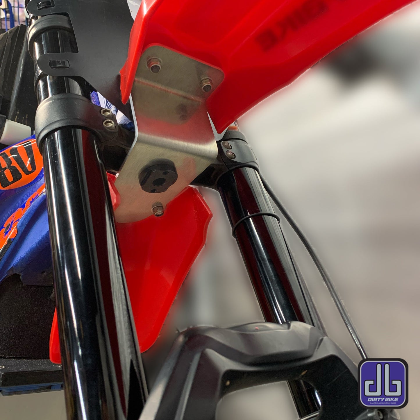 eDirtyBike high front fender mounting kit for Surron LBX and Talaria Sting electric bikes, shown installed on the bike.