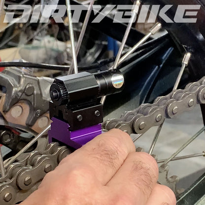 eDirtyBike Laser Chain Alignment Tool mounted on motorcycle for precise chain alignment, showcasing the motorcycle and tool in use.