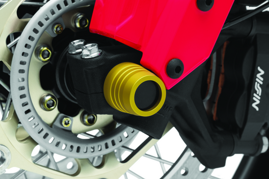 Kuryakyn front axle slide for Honda CRF1000L Africa Twin and Adventure Sports motorcycle, part #3829, shown installed on wheel.