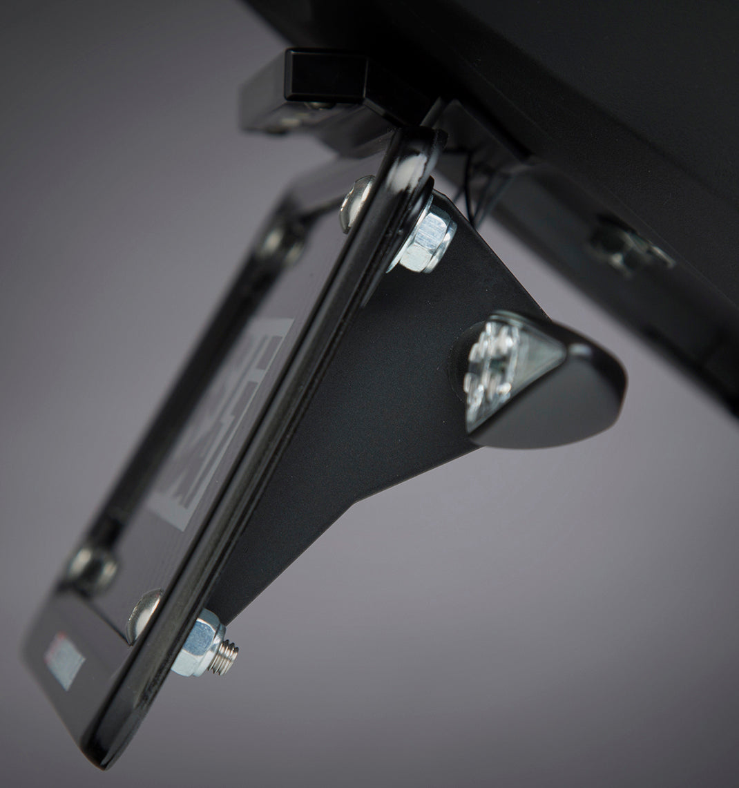 YOSHIMURA universal motorcycle turn signal bracket attached to a bike, showcasing durable metal construction and mounting points