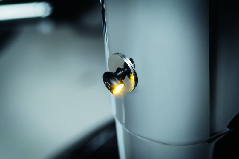 Kuryakyn Kellermann Atto clear lens amber LED motorcycle indicators with satin black housing, compact and modern design.