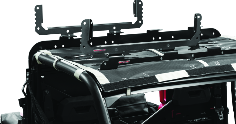 Kuryakyn Takrak Utility Cradles in black mounted on a UTV, holding tools and gear for Polaris Ranger and similar vehicles.
