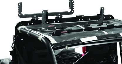 Kuryakyn Takrak Utility Cradles in black mounted on a UTV, holding tools and gear for Polaris Ranger and similar vehicles.