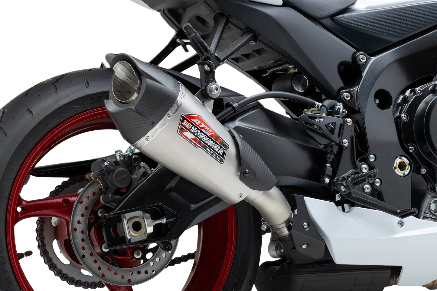 YOSHIMURA Street AT2 stainless steel exhaust with carbon fiber end cap for motorcycles, showing the sleek design and brand logo.