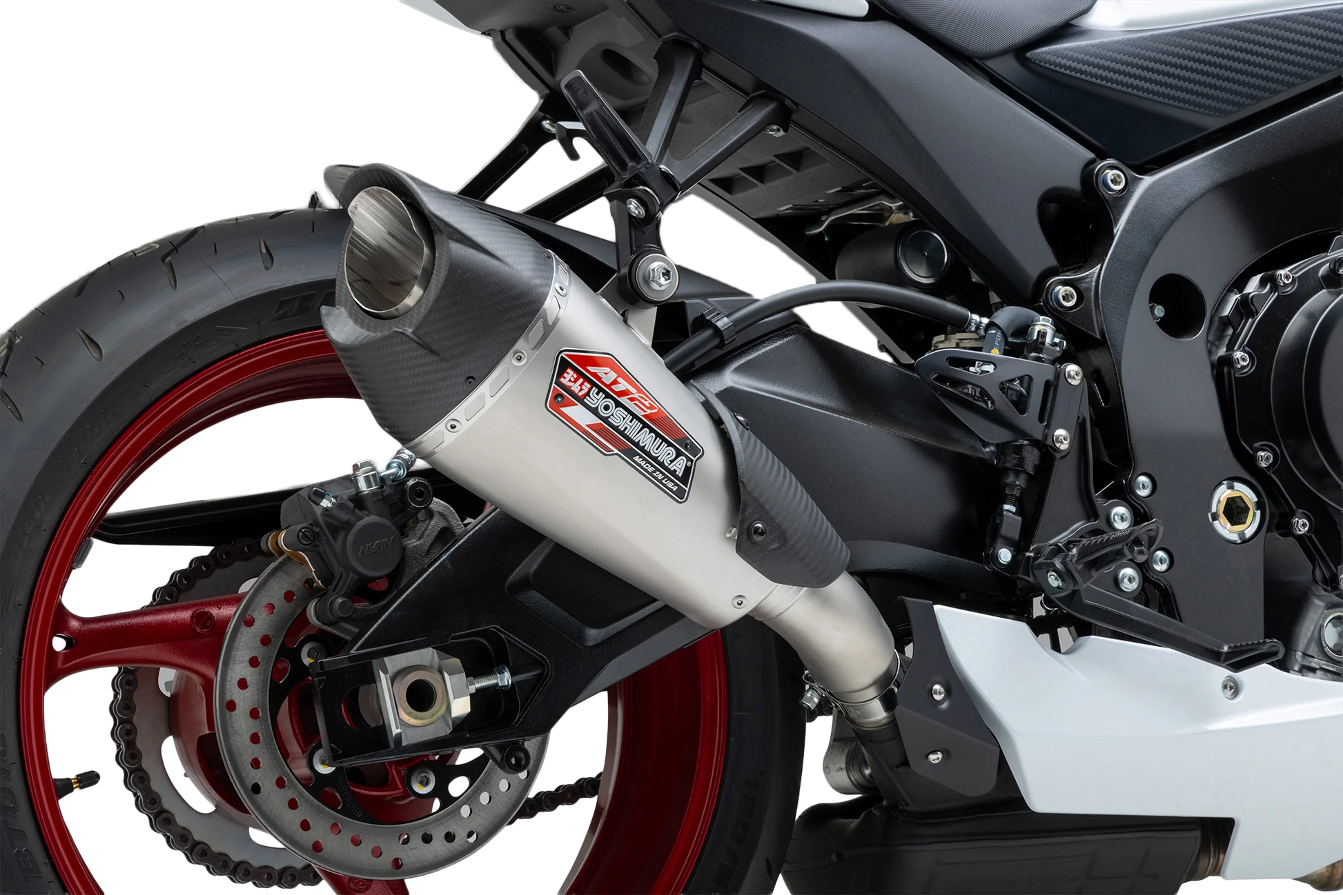 YOSHIMURA Street AT2 stainless steel exhaust with carbon fiber end cap for motorcycles, showing the sleek design and brand logo.