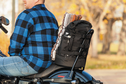 Kuryakyn Momentum Freeloader Duffle for Powersports attached to a sissy bar, black quick-mount bag with straps and zippers.
