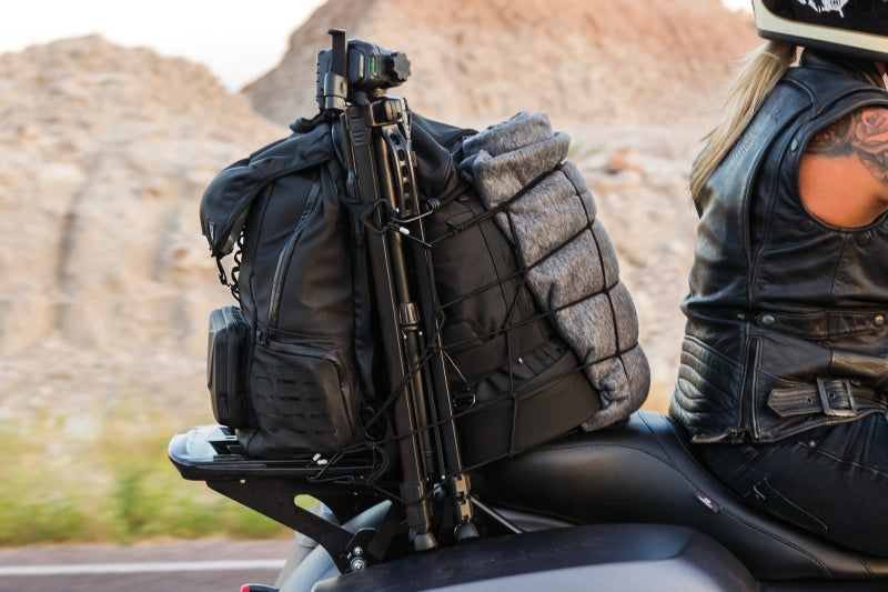 Kuryakyn Momentum Freeloader Duffle bag mounted on a powersports sissy bar, designed for quick attachment and durable storage.
