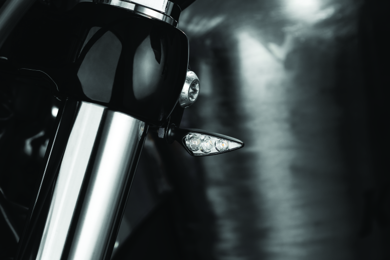 Kuryakyn Rhombus S single function front left amber turn signal with clear lens for motorcycle.