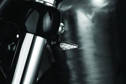 Kuryakyn Rhombus S single function front left amber turn signal with clear lens for motorcycle.