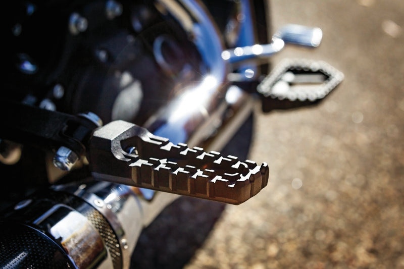 Kuryakyn Riot Pegs without adapter in satin black for powersports vehicles, showing the textured footrest design.