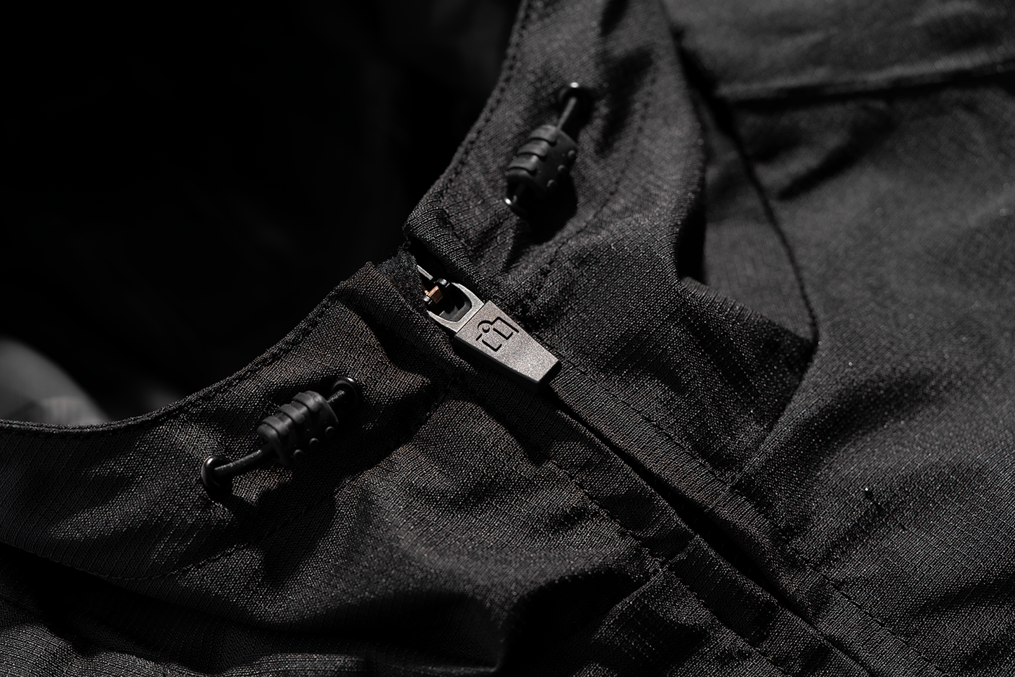 Black ICON PDX3™ jacket in XL size, featuring a sleek design and visible zipper details, by Bill's Exhausts.