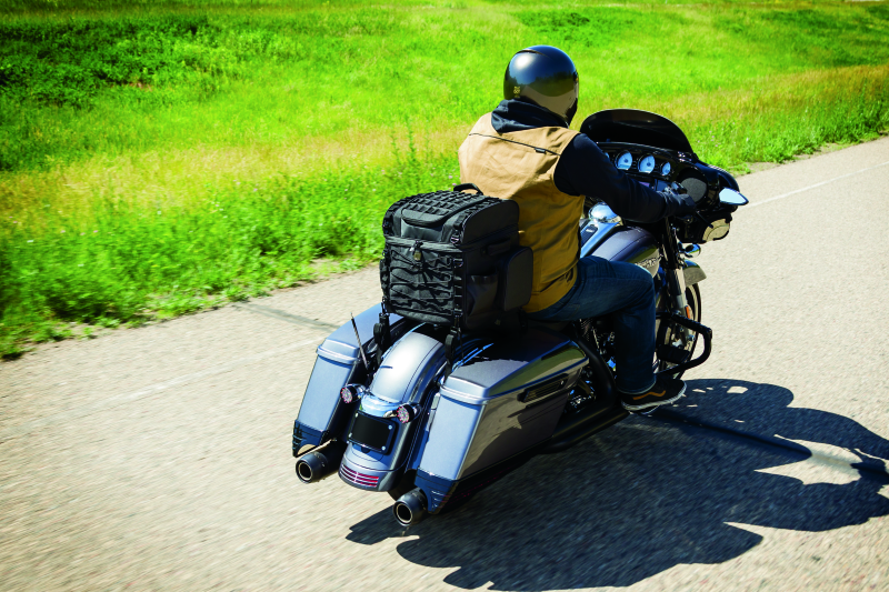 Kuryakyn Momentum Vagabond Bag mounted on motorcycle seat and luggage rack, showcasing versatile storage for motorcycle travel.