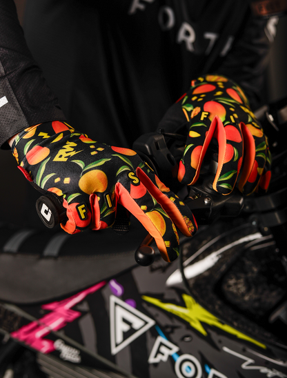 FIST Handwear Mango Madness R-Willy gloves in red label with straps, 2XS size, featuring bright red color and textured design.