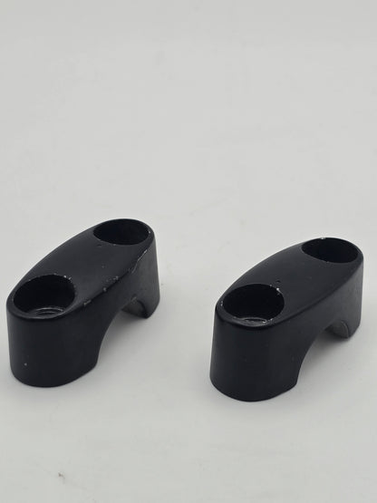 Pair of used Honda Grom OEM handlebar mounts for 2014-2020, durable handlebar holder brackets in good condition.