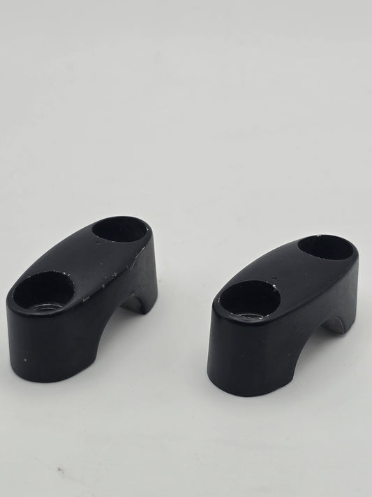 Pair of used Honda Grom OEM handlebar mounts for 2014-2020, durable handlebar holder brackets in good condition.