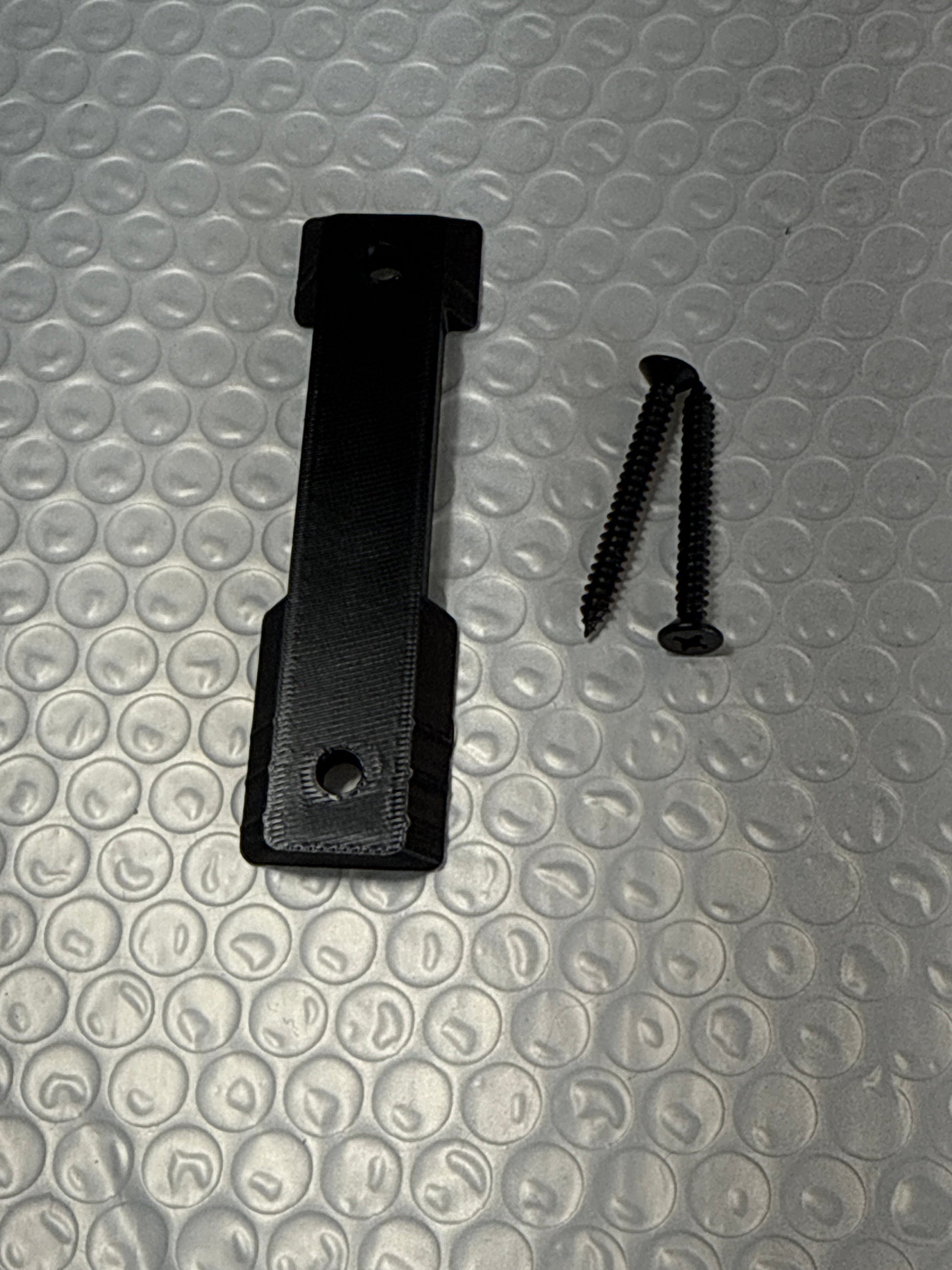 McCoy Industries helmet mount system accessory wall plate, compatible with helmet mounting systems, for secure attachment and display.
