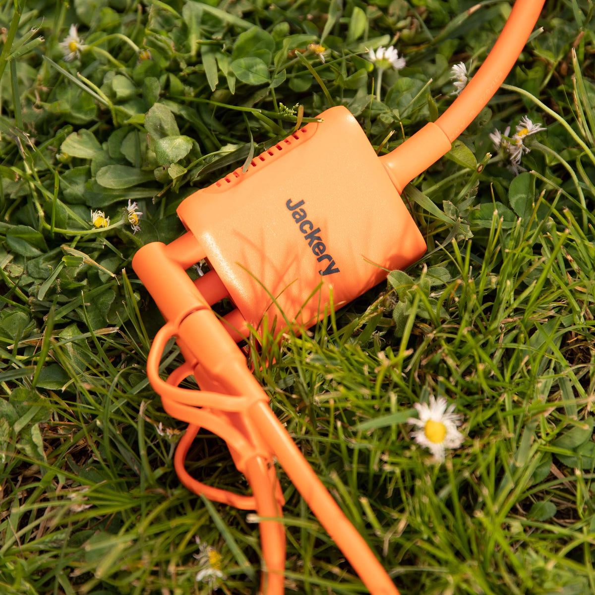 Jackery Solar Panel Connector for handbags, showing a compact, portable connector device with branding details.