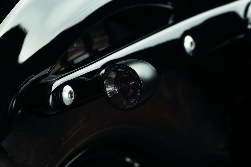 Kuryakyn Bullet 1000 LED turn signal light with white/amber clear lens and satin black housing for powersports vehicles.