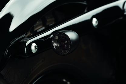 Kuryakyn Bullet 1000 LED turn signal light with white/amber clear lens and satin black housing for powersports vehicles.