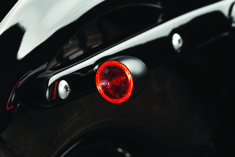 Kuryakyn Bullet 1000 LED turn signal light with white/amber clear lens and satin black finish for powersports vehicles.