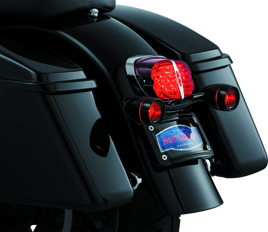 Kuryakyn Bullet Light Rear Turn Signal Bar for Harley Davidson in gloss black, featuring sleek design and mounting hardware