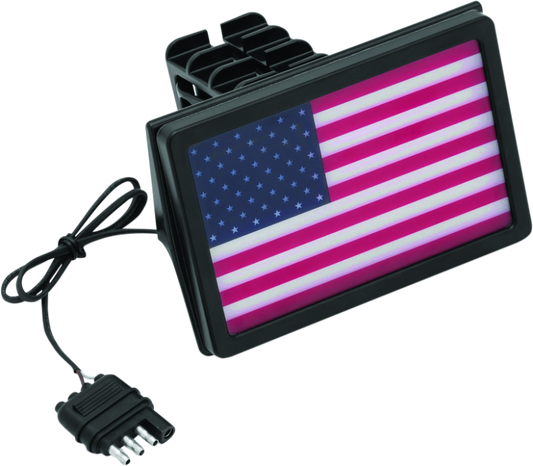 Kuryakyn Freedom Flag LED Hitch Cover in black attached to a vehicle's receiver hitch, fits 1-1/4 inch and 2-inch hitch receivers.