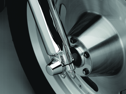 Chrome Kuryakyn front axle nut caps for Harley Davidson and Sportster motorcycle models, showcasing polished metal finish.