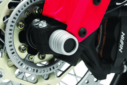 Kuryakyn front axle slide for Honda CRF1000L Africa Twin and Adventure Sports models, part #3826, shown on motorcycle axle.