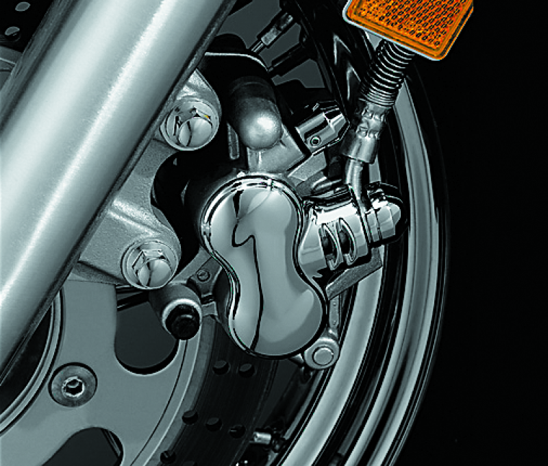 Kuryakyn front caliper cover in chrome finish for Kawasaki Vulcan 900 Classic motorcycle, showcasing polished metal design.
