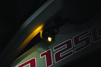Kuryakyn Kellerman turn signal adapter kit for BMW motorcycles, showing the black wiring harness and installation components.