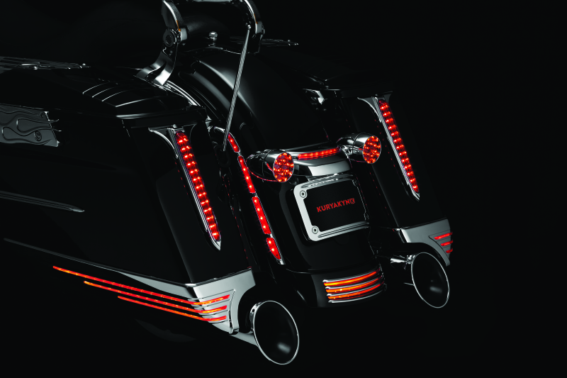 Kuryakyn LED turn signal bar filler panel for Harley Davidson FLHX and FLTRX models, black plastic with integrated LEDs.