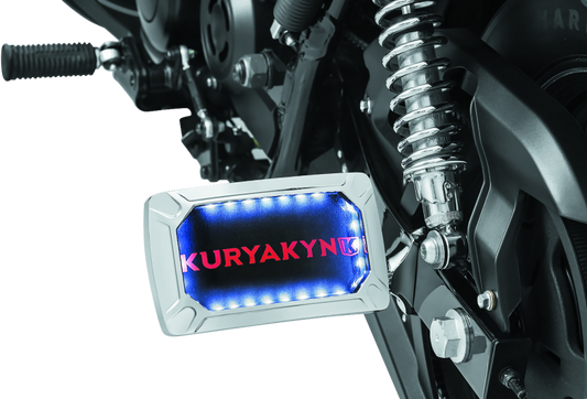 Kuryakyn Nova curved horizontal side license plate holder with integrated LED lighting for motorcycles.
