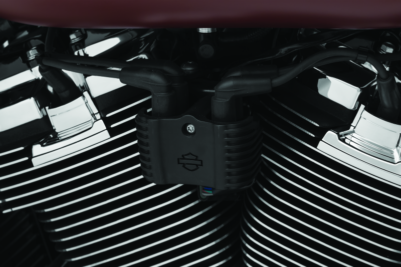 Chrome Kuryakyn Precision Coil Cover for Harley-Davidson Softail models, part #6466, shown on a motorcycle engine.
