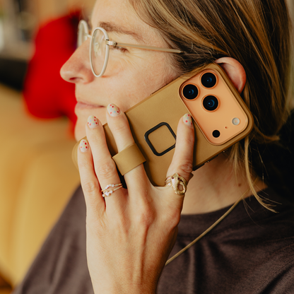 Peak Design Everyday Loop Case for iPhone 17 Pro in tan, showing protective mobile phone cover with loop strap design.
