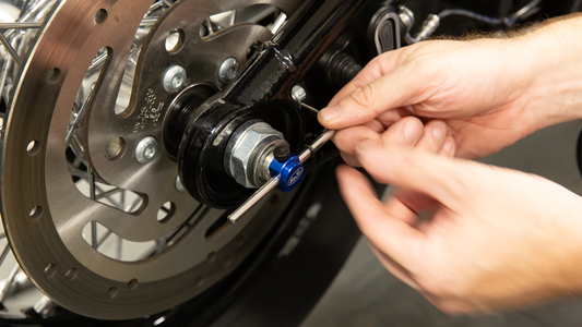 Motion Pro wheel alignment tool for Harley Davidson M8 Softails, showing the durable black plastic device with measurement markings