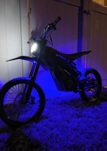 Purple Hyperglow Surron Ultra Bee under glow kit installed on front and rear of Surron electric bike by Project9.