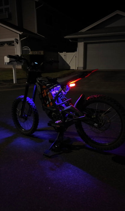 Purple rear underglow kit for Surron Light Bee by Project9, illuminating the underside of the electric dirt bike.
