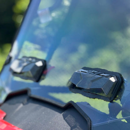 SEIZMIK tool-less UTV windshield made of hard-coated polycarbonate, shown installed on a UTV for protection against elements.