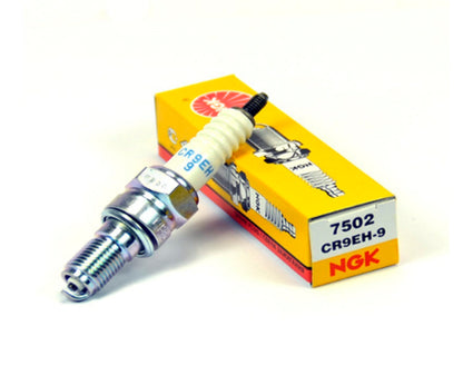 NGK CR9EH-9 spark plug for Honda engines, showing the new standard spark plug with metal shell and insulator, three-pack.