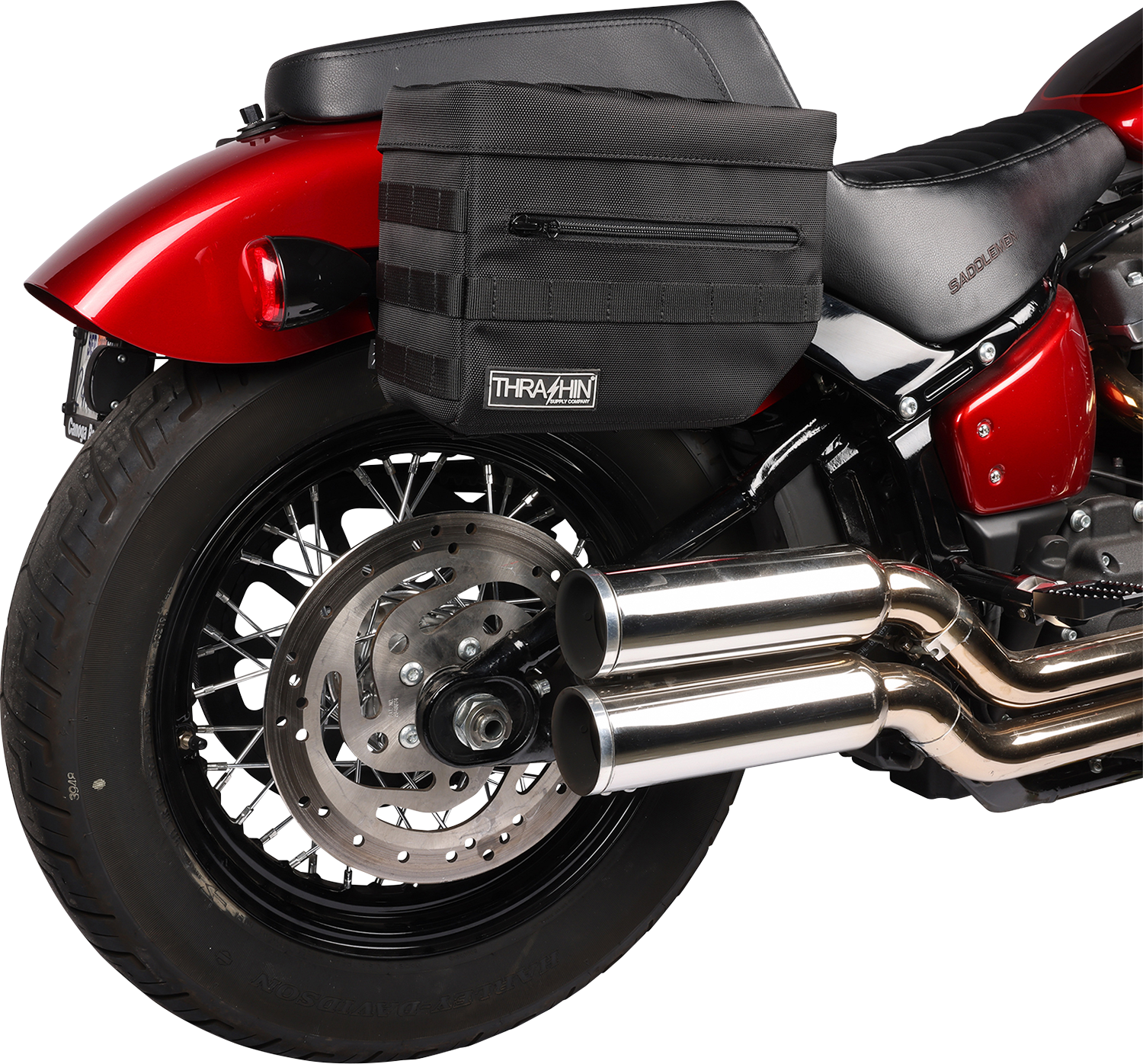 Black THRASHIN SUPPLY CO. Essential Saddlebags TSB-0006 with 10-liter storage capacity, shown on motorcycle with secure straps.