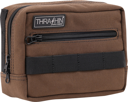 Brown THRASHIN SUPPLY CO. handlebar bag with MOLLE webbing and multiple attachment points for cycling accessories.