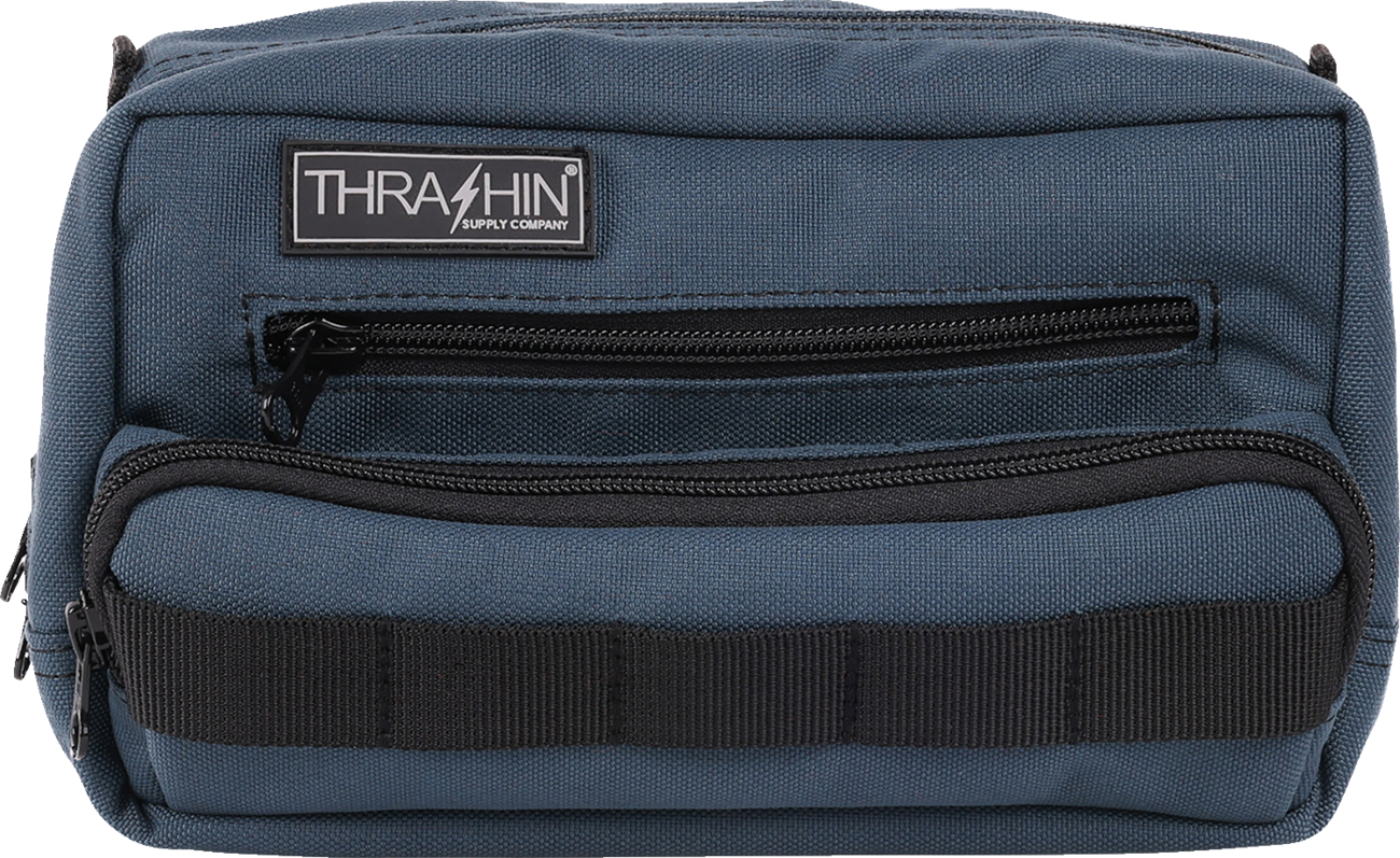 Blue THRASHIN SUPPLY CO. Handlebar Bag Plus mounted on a bicycle handlebar, showcasing its compact design and secure attachment system.