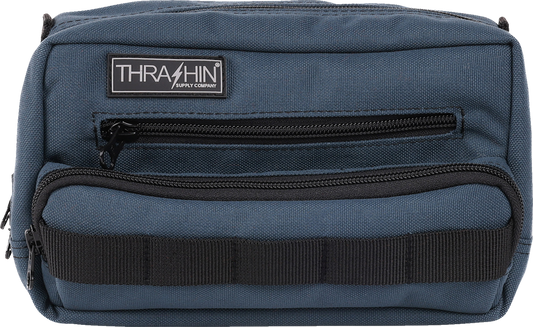 Blue THRASHIN SUPPLY CO. Handlebar Bag Plus mounted on a bicycle handlebar, showcasing its compact design and secure attachment system.
