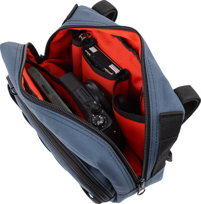 Blue THRASHIN SUPPLY CO. Handlebar Bag Plus mounted on a bicycle handlebar, showcasing its compact, durable design for cycling storage.